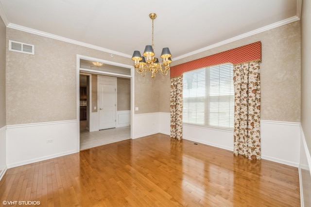 14112 Redmond Dr, Huntley, IL 60142 - unfurnished room with crown molding, an inviting chandelier, visible vents, and hardwood / wood-style flooring