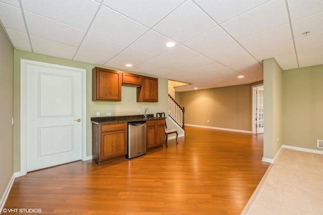 14112 Redmond Dr, Huntley, IL 60142 - kitchen with brown cabinets, dark countertops, light wood-type flooring, and stainless steel dishwasher