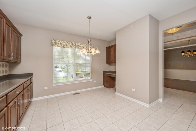 14112 Redmond Dr, Huntley, IL 60142 - unfurnished dining area with light tile patterned floors, a notable chandelier, visible vents, and baseboards