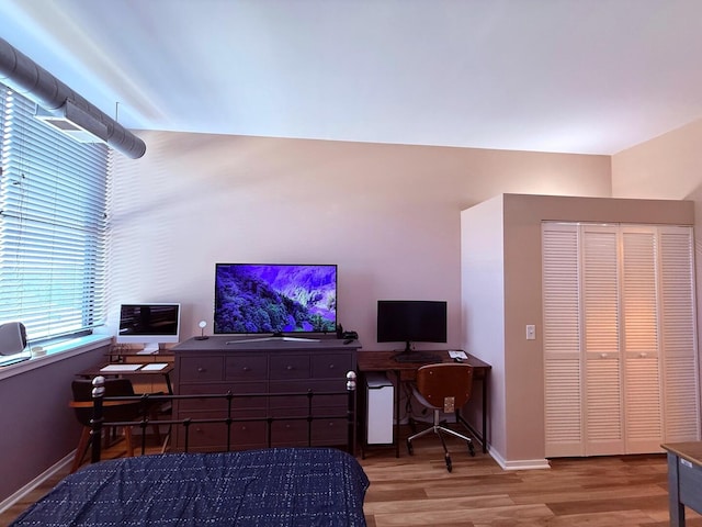 bedroom with wood finished floors and baseboards