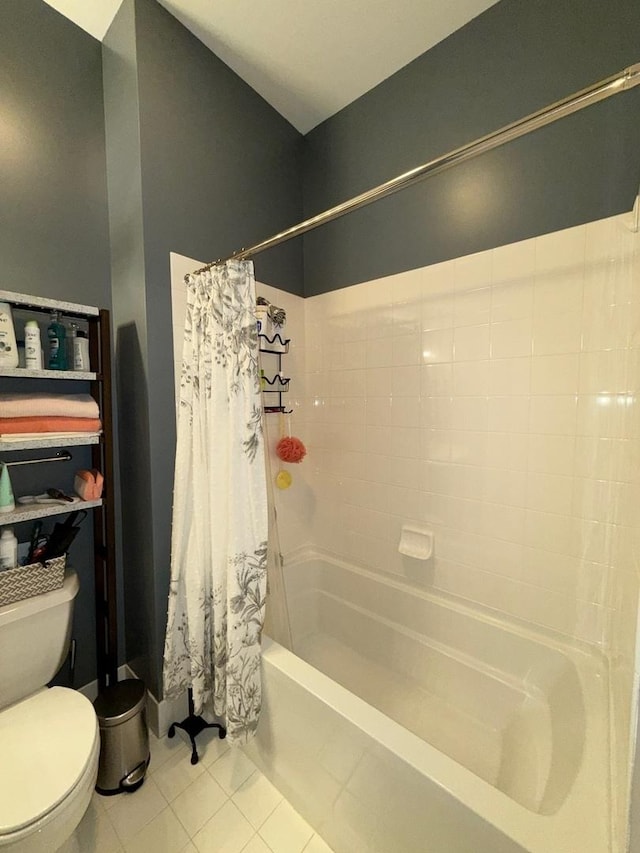 bathroom with toilet, tile patterned flooring, and shower / tub combo