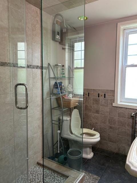 3717 W Addison St, Chicago, IL 60618 - full bath with tile walls, a shower stall, tile patterned flooring, and toilet