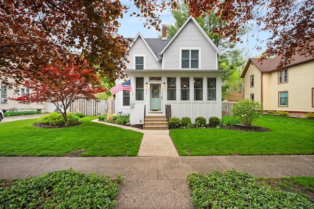 traditional-style home featuring a chimney, board and batten siding, and a shingled roof