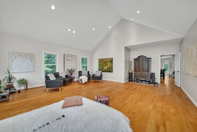 bedroom with high vaulted ceiling, light wood-type flooring, recessed lighting, and baseboards