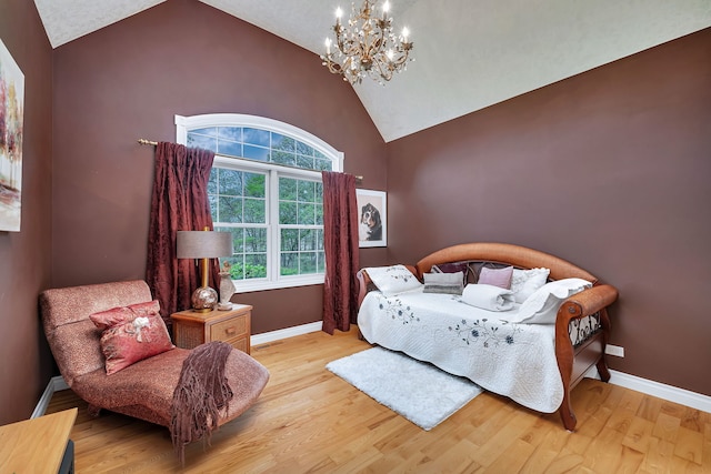 bedroom featuring a chandelier, wood finished floors, high vaulted ceiling, and baseboards