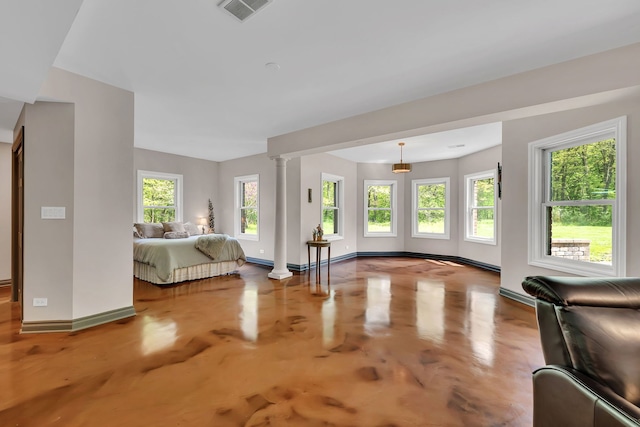 living room with baseboards, a baseboard radiator, and ornate columns