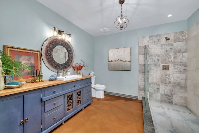 bathroom featuring walk in shower, toilet, vanity, and a chandelier