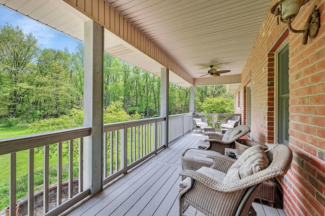 wooden deck with ceiling fan and covered porch
