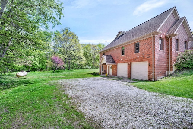 view of side of home featuring an attached garage, brick siding, a yard, gravel driveway, and a shingled roof