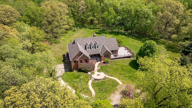 view of subject property featuring a heavily wooded area