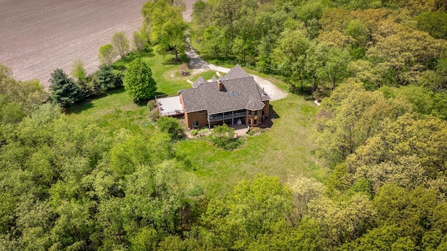 view of subject property with a forest