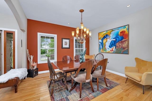dining area featuring a chandelier, baseboards, light wood finished floors, and recessed lighting