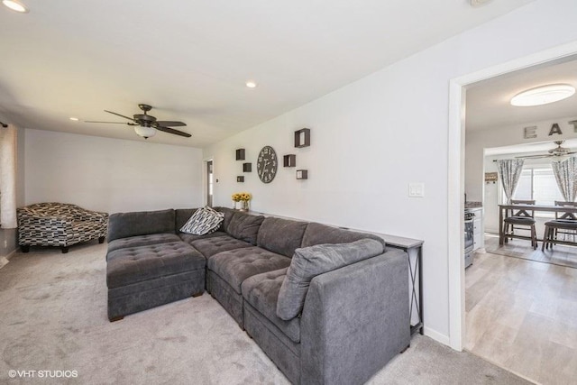 living area with baseboards, a ceiling fan, recessed lighting, and light colored carpet