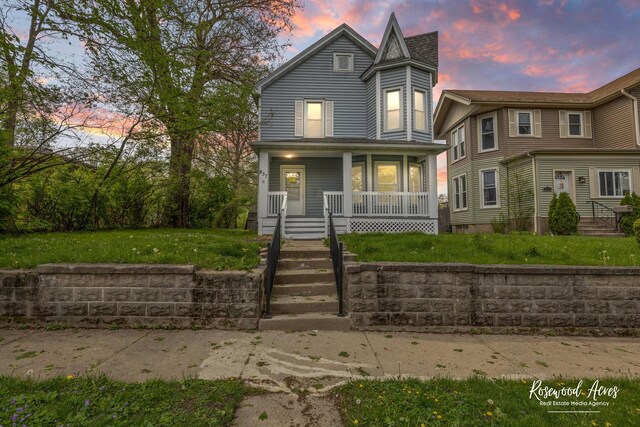 837 S 4th Ave, Kankakee, IL 60901 - view of front of house featuring covered porch and a front yard