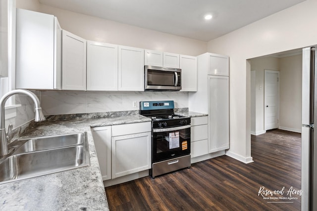 837 S 4th Ave, Kankakee, IL 60901 - kitchen with stainless steel appliances, dark wood-style flooring, tasteful backsplash, white cabinetry, and recessed lighting
