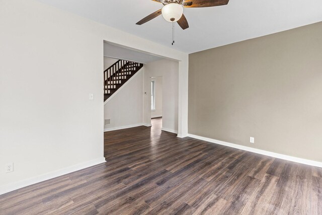 837 S 4th Ave, Kankakee, IL 60901 - unfurnished room featuring a ceiling fan, stairway, and dark wood-style floors