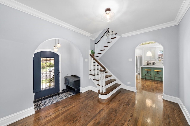 946 N Marion St, Oak Park, IL 60302 - entrance foyer with arched walkways, dark wood finished floors, ornamental molding, stairs, and baseboards