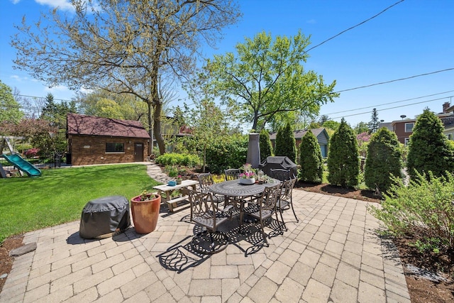 946 N Marion St, Oak Park, IL 60302 - view of patio featuring an outdoor structure, outdoor dining space, and a playground