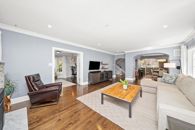 946 N Marion St, Oak Park, IL 60302 - living room with arched walkways, wood finished floors, ornamental molding, recessed lighting, and stairs