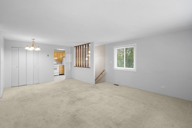 121 Cotuit Ct Unit 121, Schaumburg, IL 60193 - unfurnished living room with a chandelier and light carpet