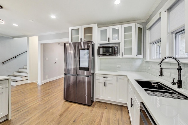 5824 N Fairfield Ave, Chicago, IL 60659 - kitchen with a sink, stainless steel appliances, crown molding, decorative backsplash, and light countertops