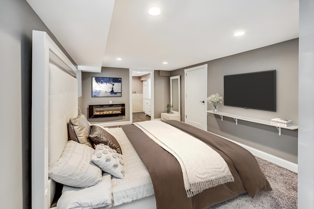 5824 N Fairfield Ave, Chicago, IL 60659 - carpeted bedroom with connected bathroom, baseboards, a glass covered fireplace, and recessed lighting