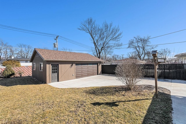 detached garage featuring fence