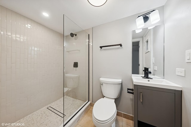 bathroom with walk in shower, vanity, toilet, and tile patterned flooring