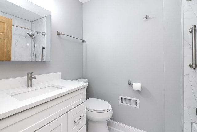 full bathroom featuring toilet, a marble finish shower, vanity, and baseboards
