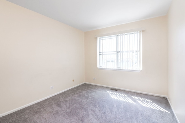 empty room with carpet flooring and baseboards