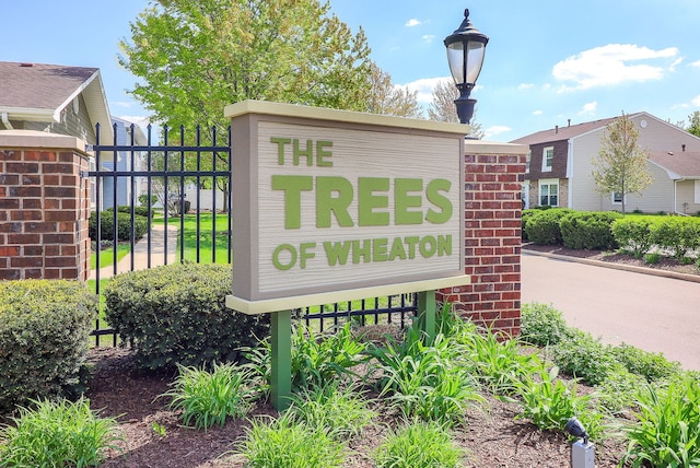 community / neighborhood sign with fence