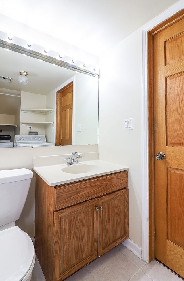 half bath featuring toilet, tile patterned flooring, and vanity