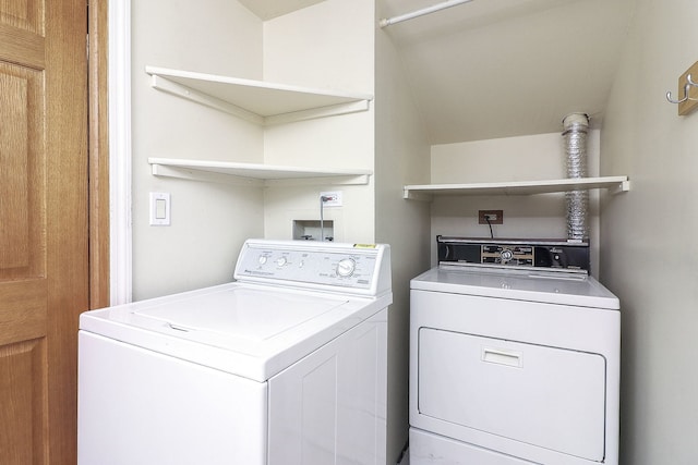 clothes washing area featuring independent washer and dryer