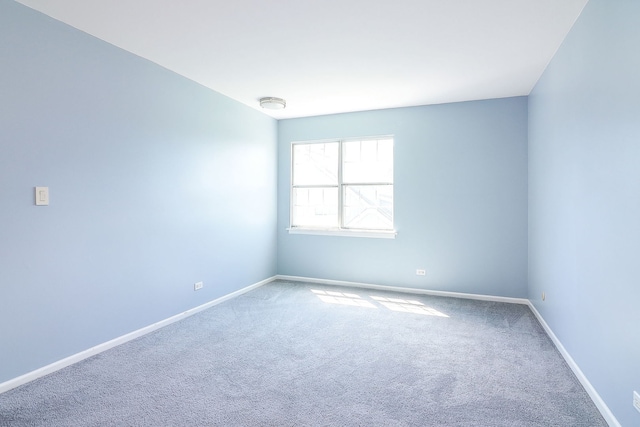 spare room with carpet flooring and baseboards