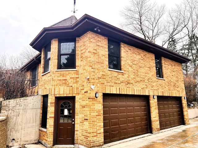 view of front of home with an attached garage and brick siding