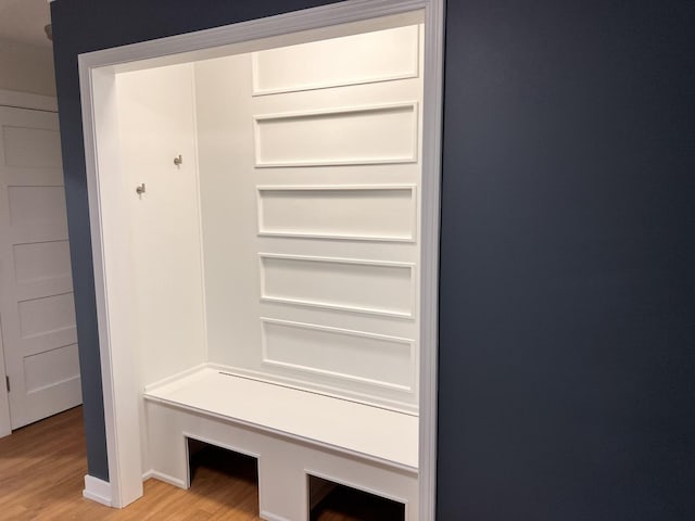 mudroom featuring baseboards and light wood-style floors