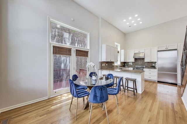 1214 N Marion Ct Unit A, Chicago, IL 60622 - dining space with a high ceiling, light wood-type flooring, and recessed lighting