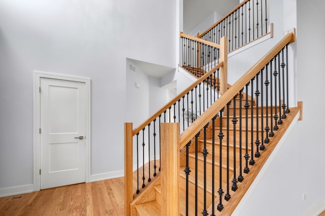 20445 Spirea Ln, Crest Hill, IL 60403 - staircase featuring baseboards, a high ceiling, and wood finished floors