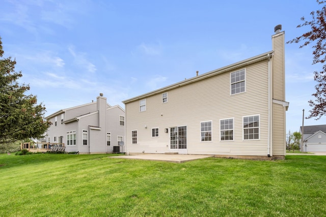 20445 Spirea Ln, Crest Hill, IL 60403 - rear view of house with cooling unit, a patio, a chimney, and a lawn