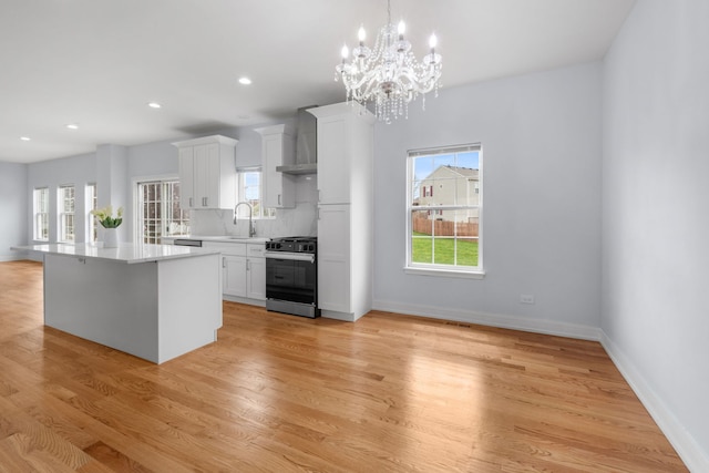 20445 Spirea Ln, Crest Hill, IL 60403 - kitchen featuring range, a healthy amount of sunlight, a chandelier, light countertops, and white cabinets