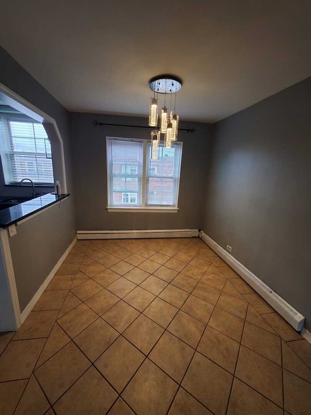 unfurnished dining area with a baseboard radiator, a wealth of natural light, and light tile patterned floors