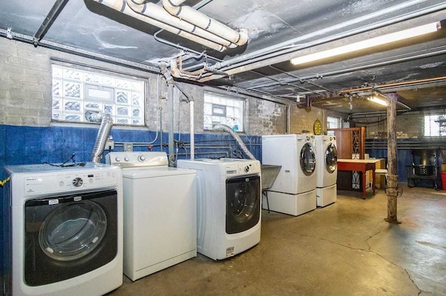 clothes washing area with laundry area and washer and clothes dryer