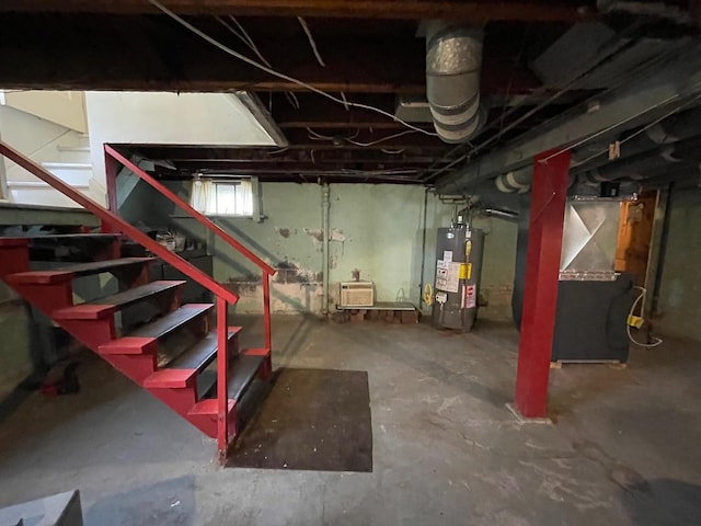 basement with water heater and stairway