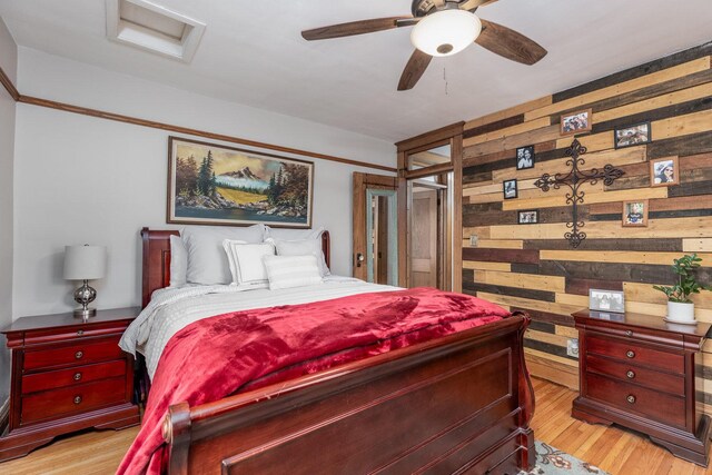 621 Marcy St, Ottawa, IL 61350 - bedroom with wooden walls, light wood-type flooring, and a ceiling fan