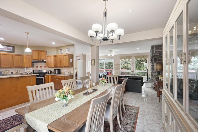 dining area featuring ceiling fan with notable chandelier and recessed lighting