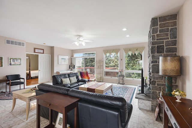living room with ceiling fan, visible vents, and recessed lighting