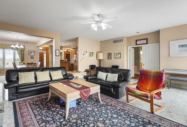 living room featuring visible vents and ceiling fan with notable chandelier