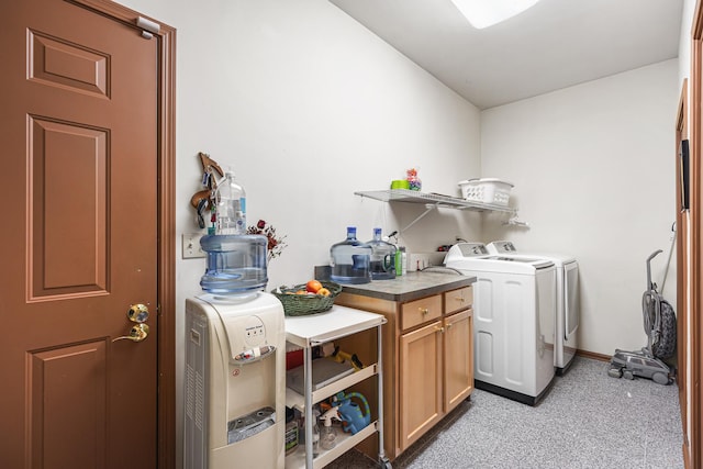 clothes washing area featuring washer and dryer, laundry area, and baseboards