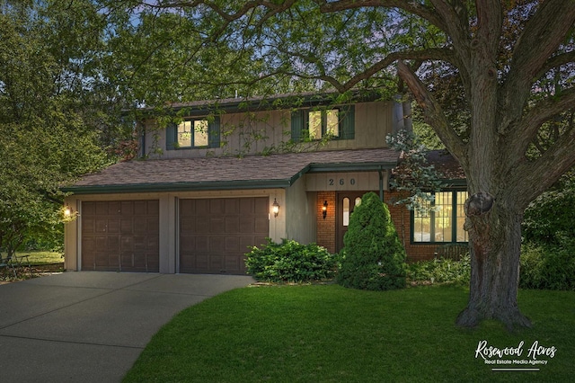 traditional home featuring concrete driveway, brick siding, an attached garage, and a front yard