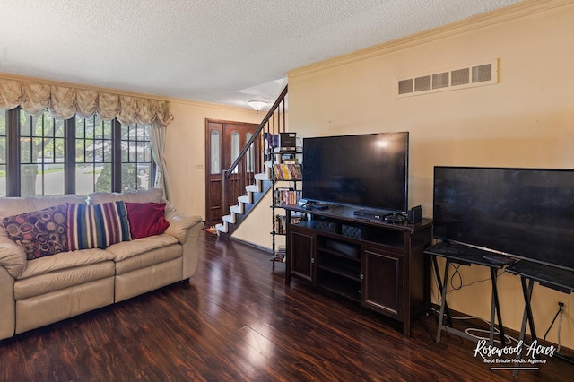 living room featuring wood finished floors, crown molding, a textured ceiling, visible vents, and stairs